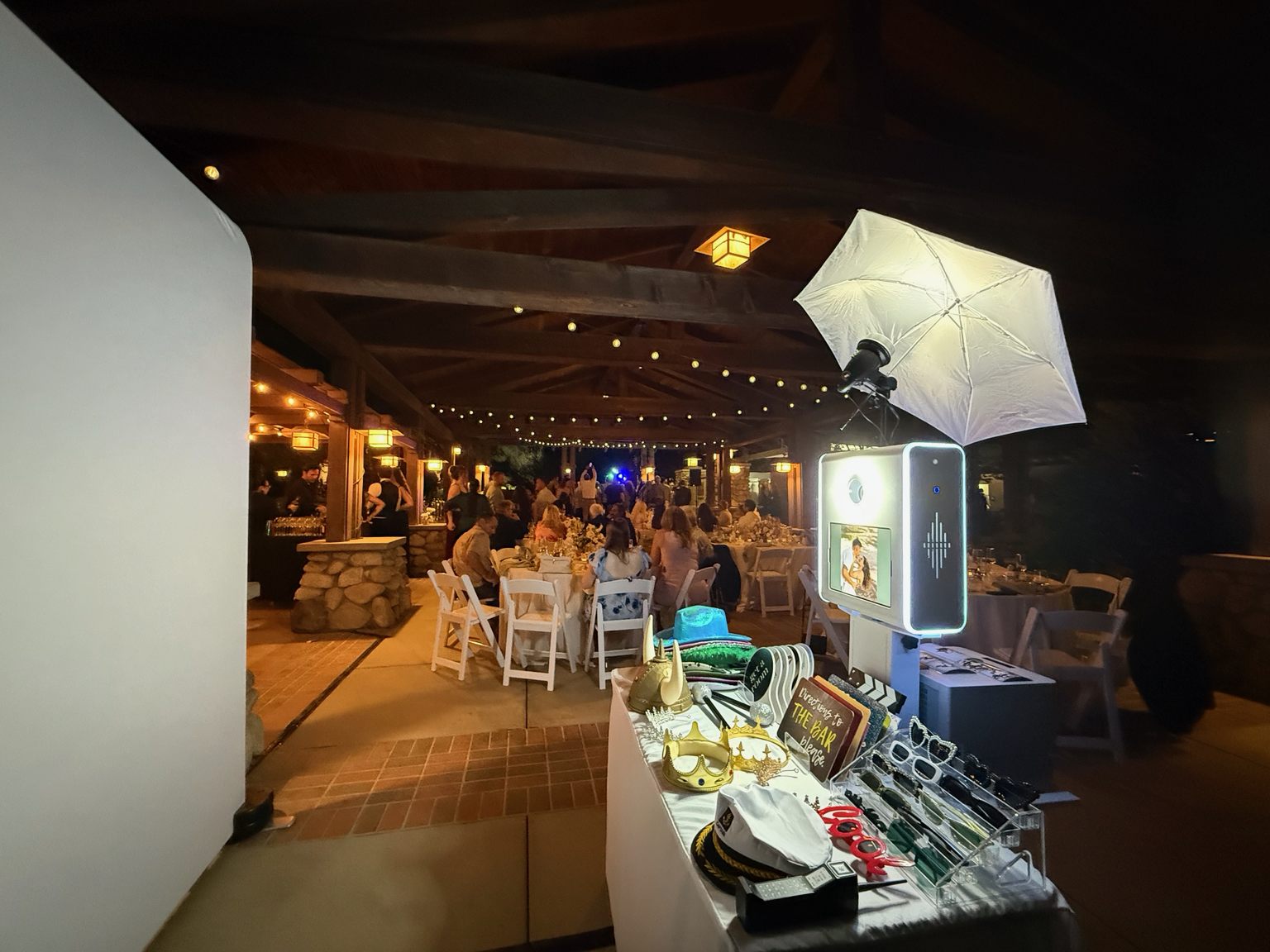 Snap My Events DSLR iPad photo booth with umbrella strobe and prop table at an outdoor wedding
